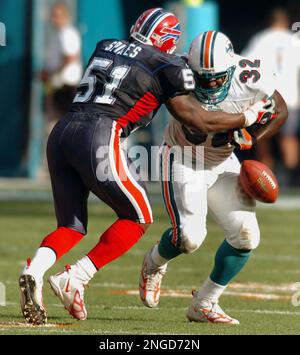 Miami Dolphins fullback Jamar Martin (32) tries to fend off Buffalo's Takeo  Spikes (51) on December 5, 2004 during first half action against the Buffalo  Bills at Pro Player Stadium in Miami ,