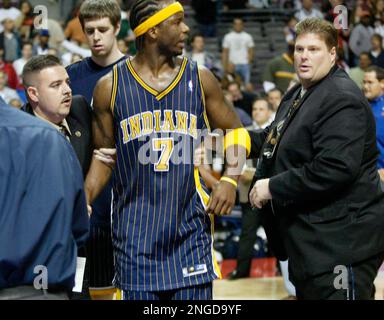FILE - Indiana Pacers' Stephen Jackson (1) is escorted off the court by  following their fight with the Detroit Pistons and fans Nov. 19, 2004, in  Auburn Hills, Mich. Ron Artest and Jackson charged into the stands and  fought with fans in the final minut