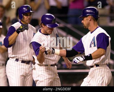 Arizona Diamondbacks' Craig Counsell, left, holds his sons, Brady Counsell,  left, and Jack Taylor Counsell, and Luis Gonzalez with his triplets Jacob  Gonzalez, center, Megan Gonzalez, far right, and Alysa Gonzalez ride