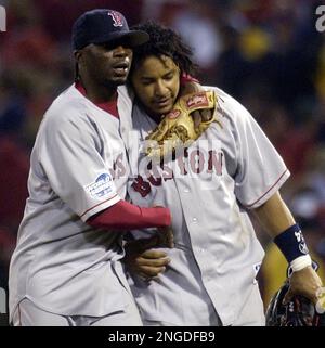 Boston Red Sox' Pokey Reese, left, hugs Manny Ramirez after the