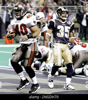 Arizona Cardinals Larry Fitzgerald jumps to catch the football for a  37-yard gain in front of St. Louis Rams Aeneas Williams (35) and Jerametius  Butler (23) for the first play of the