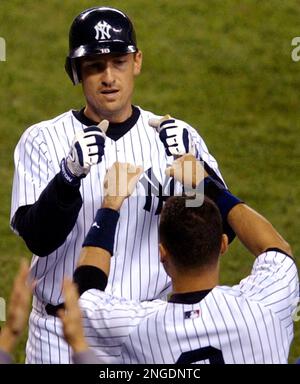 Former Seattle Mariner John Olerud wears his New York Yankees uniform as  stretches Friday, Aug. 13, 2004 during batting practice at Safeco Field in  Seattle prior to a game between the two