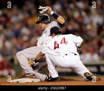 Boston Red Sox shortstop Orlando Cabrera awaits the throw from right  fielder Dave Roberts to get Detroit Tigers' Carlos Guillen trying to  stretch a single into a double during the fourth inning