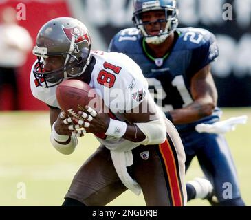 Seattle Seahawks' Ken Lucas (21) tackles Tampa Bay Buccaneers' wide  receiver Tim Brown during Sunday's game against the Seattle Seahawks at  Raymond James Stadium on Sept. 19, 2004 in Tampa, FL. The