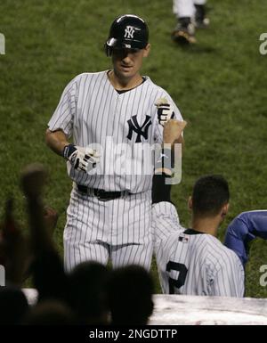 Former Seattle Mariner John Olerud wears his New York Yankees uniform as  stretches Friday, Aug. 13, 2004 during batting practice at Safeco Field in  Seattle prior to a game between the two