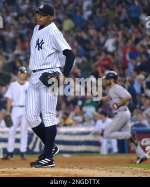 New York Yankees pitcher Orlando Hernandez delivers a pitch to the Boston  Red Sox in the first inning Friday night, Sept. 17, 2004, at Yankee Stadium  in New York. (AP Photo/Bill Kostroun