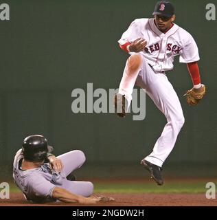 Boston Red Sox shortstop Orlando Cabrera awaits the throw from right  fielder Dave Roberts to get Detroit Tigers' Carlos Guillen trying to  stretch a single into a double during the fourth inning