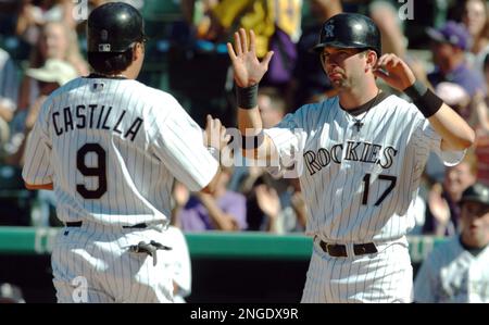 Colorado Rockies' Vinny Castilla, right, is congratulated by