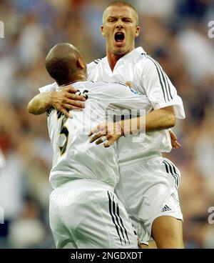 Real Madrid's Brazilian Roberto Carlos is congratuled by Sergio