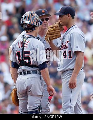 Detroit Tigers pitching coach Bob Cluck, left, takes time to give