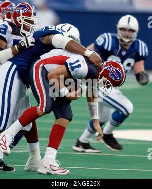 Tampa Bay Buccaneers fullback Mike Alstott (40) is tripped up by  Indianapolis Colts' Raheem Brock (79), while Colts' Montae Reagor (90)  chases during the first quarter Monday night Oct. 6, 2003 in