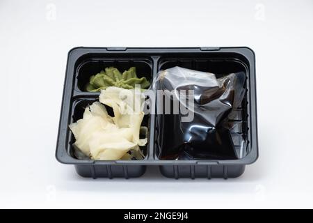 plastic food container with sushi from restaurant on isolated background, takeaway food order Stock Photo