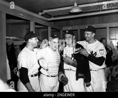 Tommy Henrich, Yankees' first sacker, is embraced by pitcher Allie