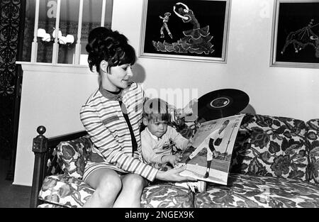 Sharyn McLain, wife of Detroit Tigers star pitcher Denny McLain, sits with  their three-year-old daughter Kristi as she looks at an album featuring a  recording of her husband's organ music with the Denny McLain Quartet, in  Detroit, Mich., on September 1