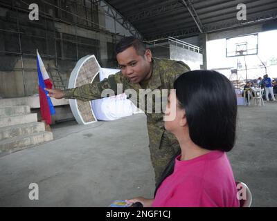 Palapag, Philippines. 18th February, 2023. Soldiers assisting patients during the 26th Mindanao Humanitarian Volunteers for Peace (MHVP) medical mission in Palapag town in Northern Samar. The free eye check-up, cataract operation and medical mission is aimed of bringing basic government services in conflict-torn areas in the Philippines infested by the communist-terror-group NPA.  (Credit Image: © Sherbien Dacalanio/Alamy Live News) Stock Photo