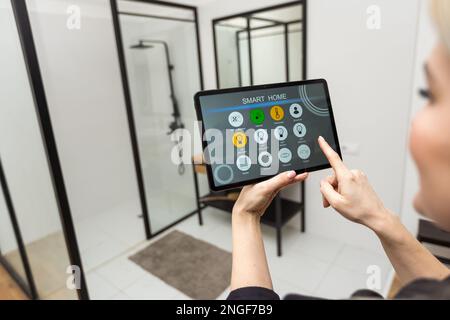 Digital composite of Hands using smart home application on tablet PC Stock Photo