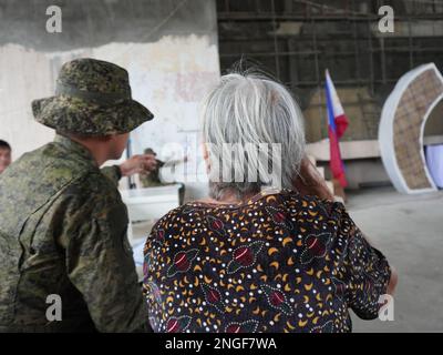 Palapag, Philippines. 18th February, 2023. Soldiers assisting patients during the 26th Mindanao Humanitarian Volunteers for Peace (MHVP) medical mission in Palapag town in Northern Samar. The free eye check-up, cataract operation and medical mission is aimed of bringing basic government services in conflict-torn areas in the Philippines infested by the communist-terror-group NPA.  (Credit Image: © Sherbien Dacalanio/Alamy Live News) Stock Photo