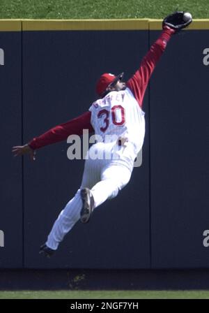 Cincinnatti Reds' Ken Griffey, Jr. can't catch the ball hit by