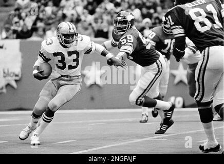 Dallas Cowboys Tony Dorsett (33) takes handoff from quarterback Roger  Staubach (12) game against the Pittsburgh Steelers shown in 1977. Dorsett,  the Heisman Trophy winner who sprinted his way into a select