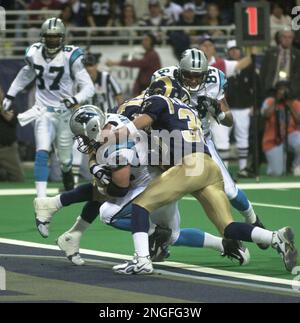 Arizona Cardinals Larry Fitzgerald jumps to catch the football for a  37-yard gain in front of St. Louis Rams Aeneas Williams (35) and Jerametius  Butler (23) for the first play of the