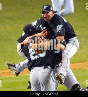 The Florida Marlins celebrate victory,waiting for Alex Gonzalez to get to  home, after hitting a walk off home run in the 12th inning against the New  York Yankees in game 4 of