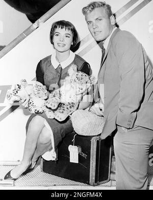 Actor Tab Hunter, left, with actress Tuesday Weld at a dinner