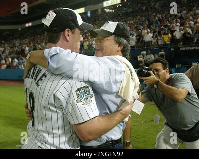 Florida Marlins owner Jeffrey Loria, left, hugs pitcher Josh