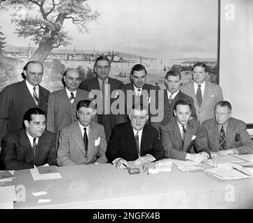 Bert Bell, commissioner of the NFL, holds football near photo mural of  Yankee Stadium in the New York Yankees' downtown office, Jan. 27, 1956. The New  York Giants of the NFL announced