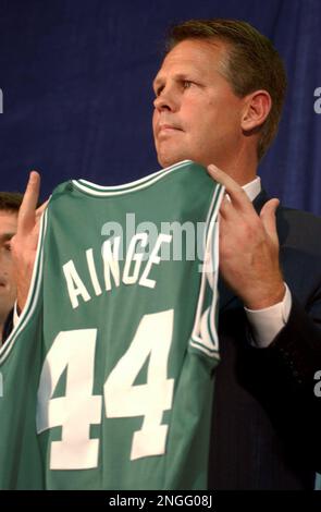 Danny Ainge holds up a Celtics jersey bearing his old number