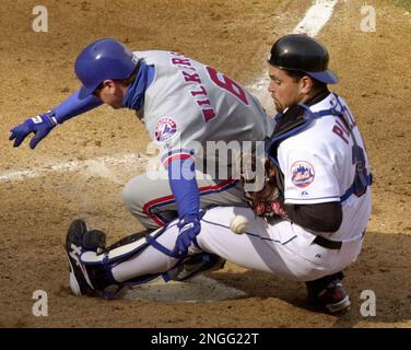 Montreal Expos former pitcher and now coach Claude Raymond, left, consoles  Brad Wilkerson as they say farewell to fans following the team's final home  game against the Florida Marlins in Montreal, Sept.