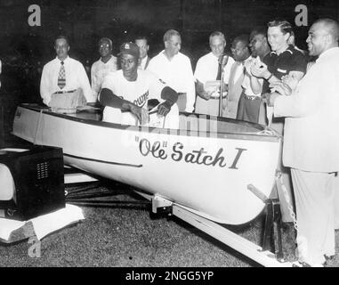 Satchel Paige, the ageless right-handed pitching star, returns to major  league baseball starting for the Browns in St. Louis, on July 19, 1951.  Here he is seen warming up prior to a