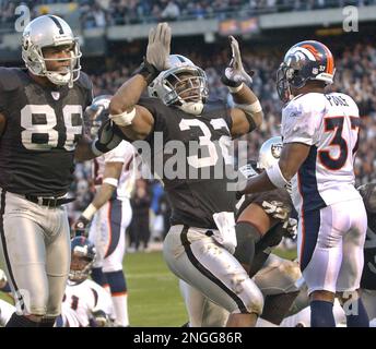 Cincinnati, United States. 14th Sep, 2003. Cincinnati Bengals linebacker  Riall Johnson shakes hands with Oakland Raiders running back Zack Crockett  after coin toss.The Raiders defeated the Bengals, 23-20, at Network  Associates Coliseum