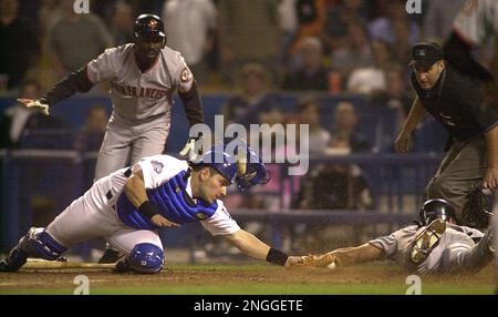 San Francisco Giants' Benito Santiago slides safely below Arizona