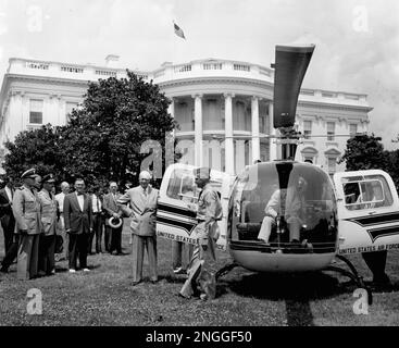 U.S. President Dwight Eisenhower stands with officials during the ...