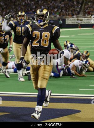 Football Hall of Fame member Marshall Faulk's name is unveiled in the St. Louis  Rams Ring of Honor during the Cincinnati Bengals-St. Louis Rams football  game at the Edward Jones Dome in