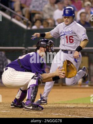 Los Angeles Dodgers' Paul Lo Duca, right, scores against Milwaukee