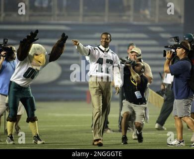 Philadelphia Eagles former quarterback Randall Cunningham enjoys a hearty  laugh as he holds his young son, Christian while being inducted into the  Eagles Honor Roll during half time ceremonies in Philadelphia at