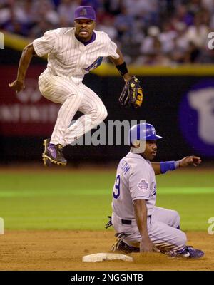 Los Angeles Dodgers' Alex Cora, bottom, hits his head into the knee of  Arizona Diamondbacks shortstop Tony Womack during a steal attempt in the  ninth inning Monday, Aug. 26, 2002, in Los