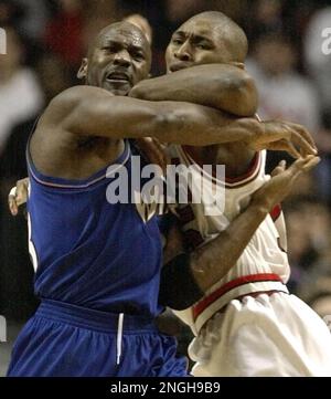 Washington Wizards' Michael Jordan, left, drives past New Jersey