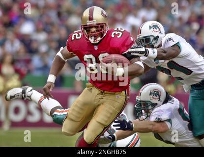 Miami Dolphins running back Terry Kirby (43) fumbles under pressure from  Dallas Cowboys Brock Marion (31), Bill Bates (40) and Leon Lett (78) in the  first quarter in Irving, Texas, Nov. 25