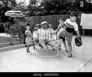 Roy Campanella, catcher for the Brooklyn Dodgers, holding six bats