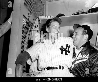 Tommy Henrich, Yankees' first sacker, is embraced by pitcher Allie