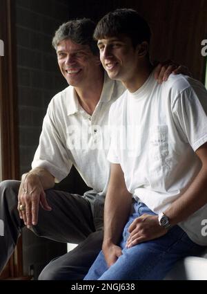 John Croyle sits with his son Brodie Croyle at the Big Oak Girls