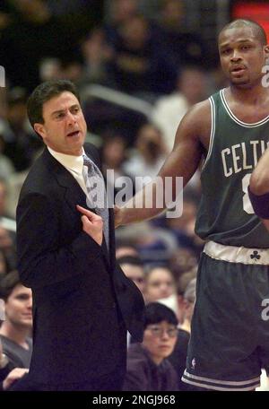 New York Knicks' John Starks is held back by teammate