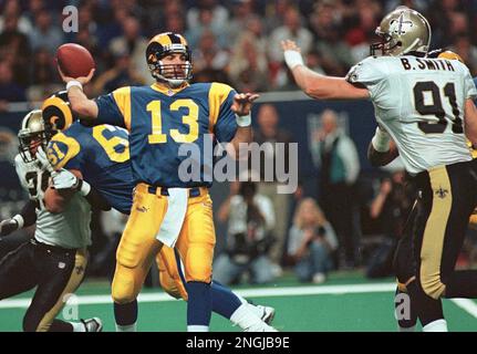 St. Louis Rams quarterback Kurt Warner (13) reaches back to pass as New  Orleans Saints Brady Smith (91) bears down in the first quarter Sunday,  Nov. 28, 1999 at the Trans World