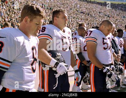 Chicago Bears' Cade McNown (8), Chris Villarrial (58) and Olin Kreutz (75)  bow their heads during a moment of silence for former Bears running back  Walter Payton before the game against the