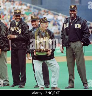 Chuck Tanner, manager of the 1979 world champion Pittsburgh Pirates, draws  a laugh from players of that team, Dave Parker, right, Steve Nicosia,  center, and Omar Moreno, left, as he plays with