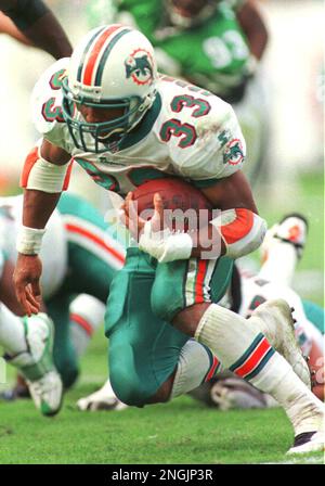 Miami Dolphins' Karim Abdul-Jabbar (33) looks up field with Pittsburgh  Steelers Willie Williams (27) in pursuit during first quarter action in  Miami Monday, Nov. 25, 1996. (AP Photo/Rick Bowmer Stock Photo - Alamy