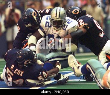 New York Giants' Keith Elias (25) flips over the goal line to score as  Chicago Bear Barry Minter (92) tackles during the fourth quarter in  Chicago, Ill., Aug. 27, 1994. The Bears