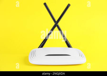 New modern Wi-Fi router on yellow background Stock Photo